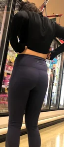 Girl with glasses shopping in leggings showing her VPL