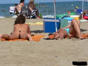 2 topless thonged sexy friends on the beach with great bodies