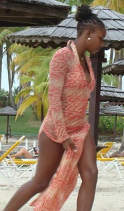 Sexy black babe in various bikinis on the beach while on vacation