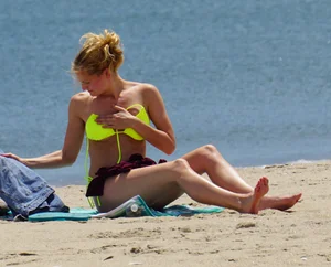 Sexy ass blonde milf on the beach in a thong with cameltoe and bending over
