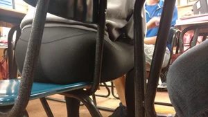 Girl in Yoga Pants Sitting in a Chair in College Classroom Closeup Creepshot