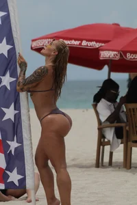 Big boobed and big assed tattood sexy chick on the beach