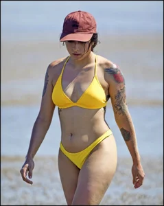 Sexy tattooed beach brunette with a great ass in yellow thong bikini