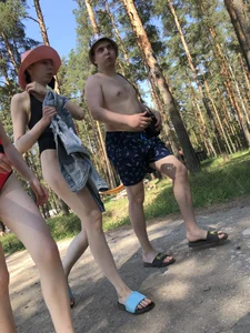 Young Girl in a One-Piece Swimsuit Walking on a Forest Road Photo Gallery