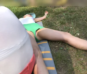 Barefoot Candid Girl in Mini Shorts Lying on the Grass in Nature Park With Spread Legs - Her Panties Sticking Out