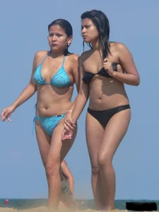 Couple of thick beach teens in little thong bikinis