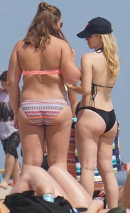 Two thick white girls in bikinis on the beach with big asses