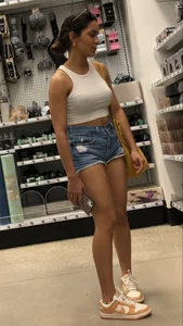 Latina in jean shorts and a crop top