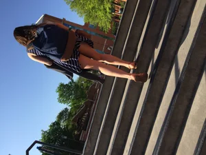 Girl in a Dress and Sandals Walking up the Stairs on a Street - Low Angle Creepshot of Her Legs