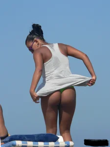 Hot ass topless beach girl with great tits lets her little brother oil up her ass in thong bikini