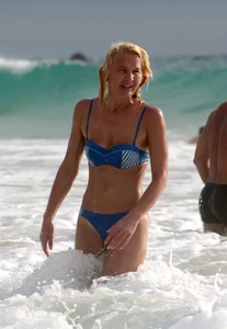 Blonde milf in a blue bikini looking sexy at the beach
