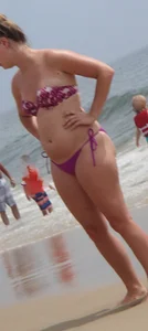 Milf booty in a purple bikini at the beach