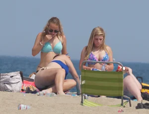 3 girls on the beach in bikinis with big boobs, one brunette and two blondes