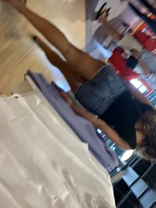 Bunch of girls in various outfits at a Cardinals baseball game
