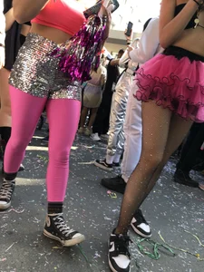 Hot carnival girl in in a top, mini shorts with pink frill and awesome legs in fishnet pantyhose