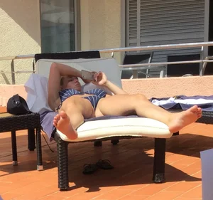 Blonde laying out in a blue bikini with a sexy body