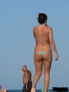 2 topless thonged sexy friends on the beach with great bodies