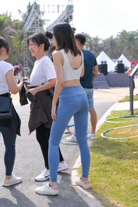 Hula hooping skinny Asian in light blue leggings with vpl