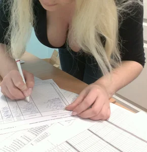 Blonde Girl Bending Over a Desk Breast Downblouse Photo
