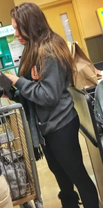 Fit shopping brunette girl in leggings and a hoodie with a nice ass