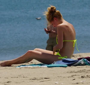 Sexy ass blonde milf on the beach in a thong with cameltoe and bending over