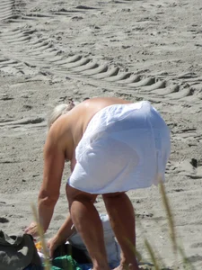 Mature blonde lady on a nude beach with big boobs