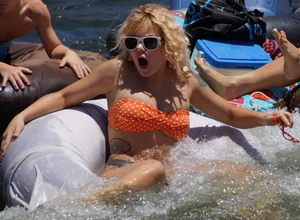 Sexy party girls in bikinis on a lake