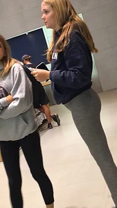 Blonde teen shopping at an Apple store in tight grey leggings