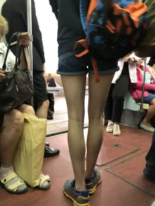 Girl in Shorts Standing in a Subway Train With Spread Legs - Creepshots Gallery