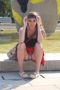 Girl in a Skirt Sitting on the Street Curb With Spread Legs Flashing Her Panties