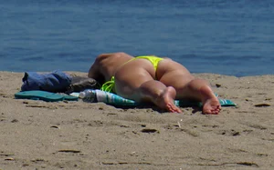 Sexy ass blonde milf on the beach in a thong with cameltoe and bending over