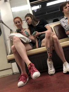 Two Girls With Hot Long Legs in Mini Shorts and Sneakers in the Subway Train Candid Photo Gallery