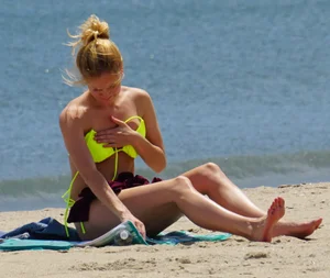 Sexy ass blonde milf on the beach in a thong with cameltoe and bending over