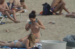 Topless girls on a beach in Barcelona