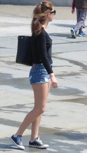 Cute girl with nice legs in short denim shorts