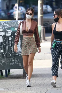 Emily Ratajkowski in mini skirt out for a walk with a friend in New York