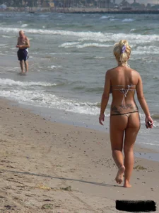 Tattooed blonde with big tits topless and in thong