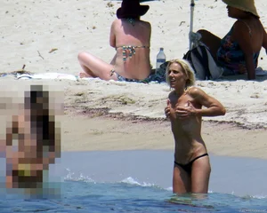 Small boobed topless milf on the beach