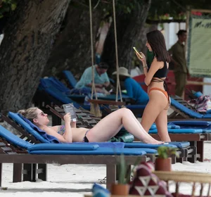 Sexy brunette friends on the beach in bikinis with great bodies