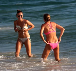 Sexy beach girl in bikini with her other sexy friend