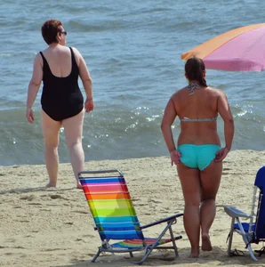 Thick beach girl in a teal bikini