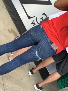 Bunch of girls in various outfits at a Cardinals baseball game