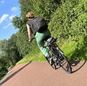 Nice bike girl in tight pants on the road creepshot