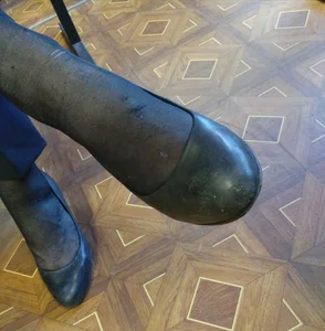 College Teen's Feet in Flats And Black Pantyhose Closeup - Sitting With Crossed Legs