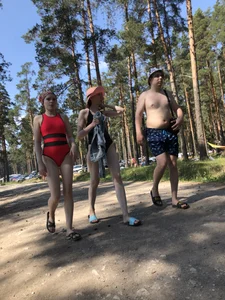 Young Girl in a One-Piece Swimsuit Walking on a Forest Road Photo Gallery