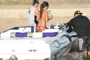 Brunette on a boat in red thong bikini with a tight little ass