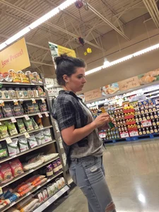 Sexy brunette grocery shopping in tight jeans