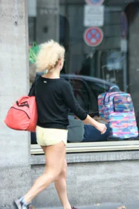 Blonde looking sexy walking in short yellow shorts