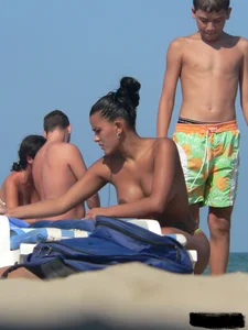 Hot ass topless beach girl with great tits lets her little brother oil up her ass in thong bikini