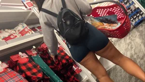 Latina squatting in spandex shorts